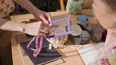 Women Learning Weaving on Small Hand Loom in Craft Workshop Stock Footage 341948893