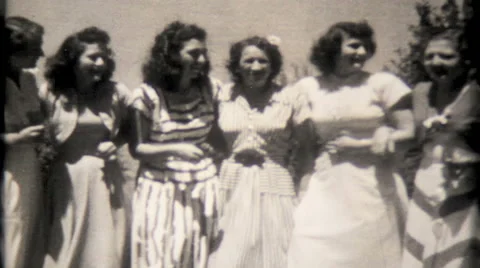 Women lock arms and walk toward camera 1950s vintage film home movie 1795 Stock Footage