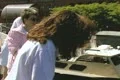 Women looking off edge of boat as it moves past other boats Footage