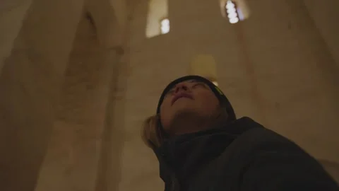 Women looking up inside an ancient stone building Stock Footage 310229643