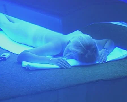 Women lying under sunbeds Stock Footage