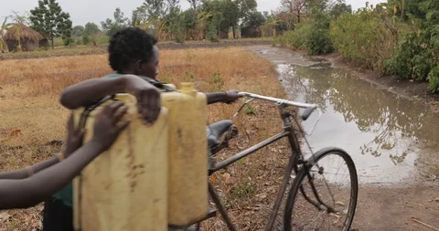 Women make Bricks from adobe pressing wet mud mixture into timber frame Stock Footage 109139801