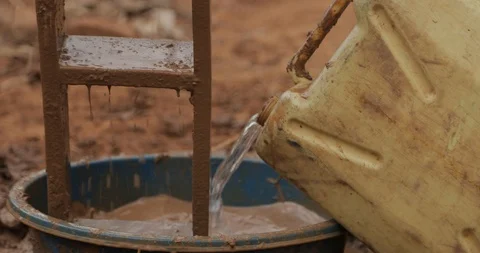 Women make Bricks, pressing mud mixture into an open timber frame, Mbale, Uganda Stock Footage 109492136
