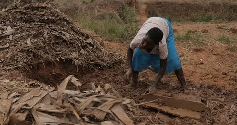 Women make Bricks, pressing mud mixture into an open timber frame, Mbale, Uganda Stock Footage 109492357