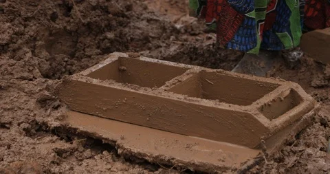 Women make Bricks, pressing mud mixture into an open timber frame, Mbale, Uganda Stock Footage 109492868