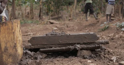Women make Bricks, pressing mud mixture into an open timber frame, Mbale, Uganda Stock Footage 109495550