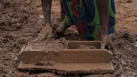 Women make Mud Bricks pressing wet mixture into a timber frame, jinja, uganda Stock Footage 109140045