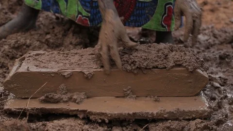 Women make Mud Bricks pressing wet mixture into a timber frame, jinja, uganda Stock Footage 109140055