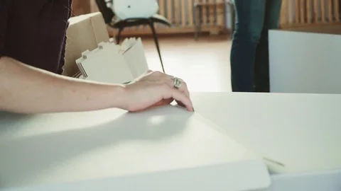 Women manually make cardboard boxes Stock Footage 120428293