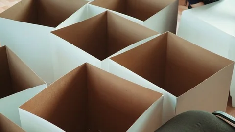 Women manually make cardboard boxes Stock Footage 120428445