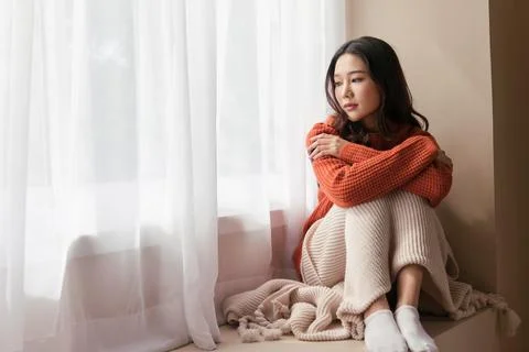 An women the pensive face looking of problems sit alone at home. Stock Photos