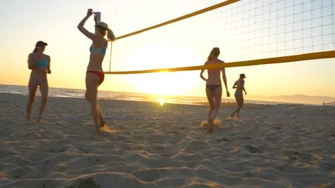 Women players play beach volleyball and celebrate a point won, slow motion. Stock Footage