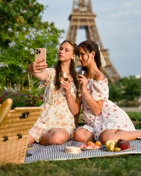 Women Posing With Wine by the Eiffel Tower Stock Photos