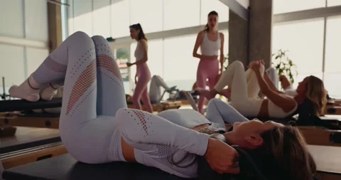 Women Practicing Pilates in Modern Studio 스톡 동영상 323935735