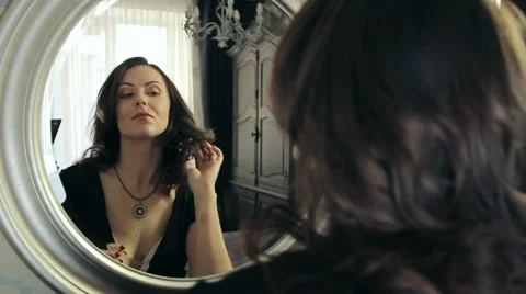 Women preen about mirror Stock Footage 10904394