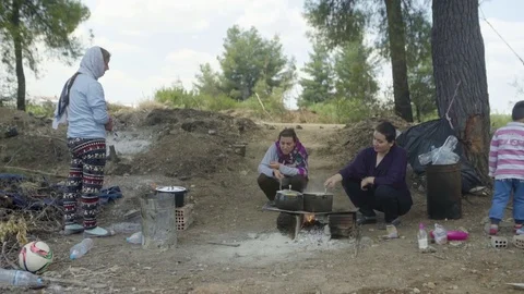 Women preparing food while talking with her family Stock Footage 77452942