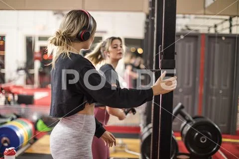 Women preparing weights equipment in gym Stock Photos