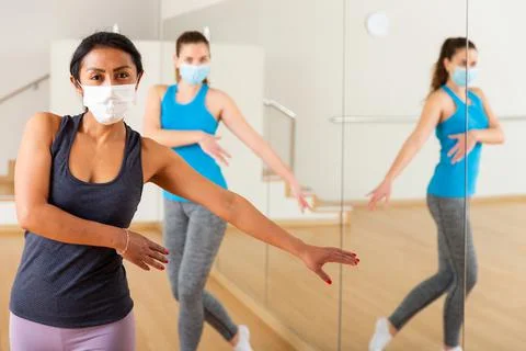Women in protection fase masks dancing aerobics Stock Photos