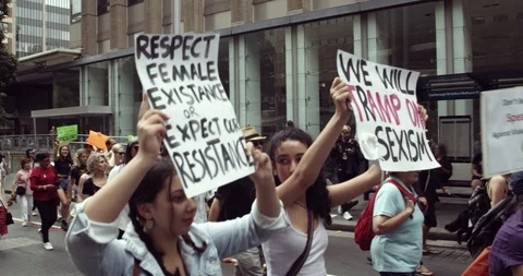 Women protesting holding signs for equal rights Stock Footage