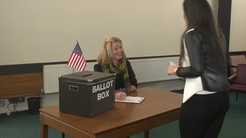 Women Queuing to Vote in the USA Presidential Election. Ballot Box on the Desk Stock Footage