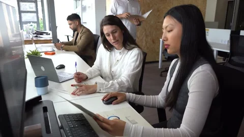Women reading documents in office Stock Footage 156725599