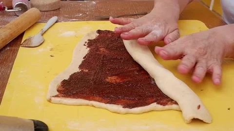Women rolling chocolate on dough Stock Footage 154336641