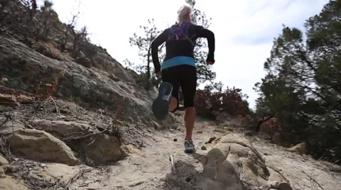 Women running up rocky trail colorado Stock Footage
