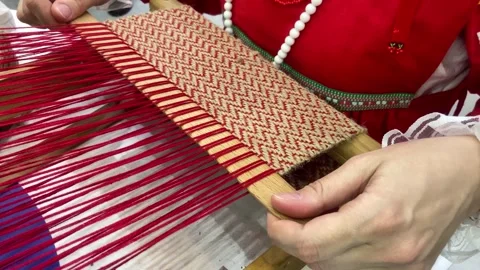 Women 's hands create a pattern using multi-colored threads . Stock Footage 261438756