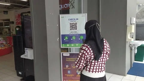 Women scan the QR code to enter the building Stock Footage 170786729