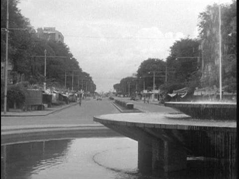 Women sell their wares outside of Saigon city hall in 1955. Stock Footage