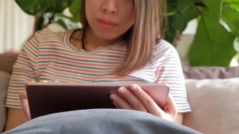 Women sitting on sofa and  using tablet computer for social network. Stock Footage 135347502