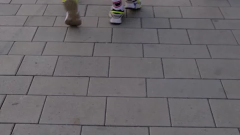 Women in sneakers walking on the sidewalk Stock Footage