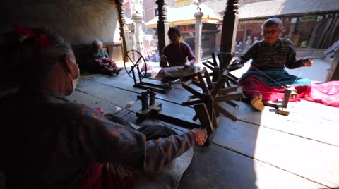 Women spin in the yard to make a string in national way. Bhaktopur, Nepal 動画素材 69050117