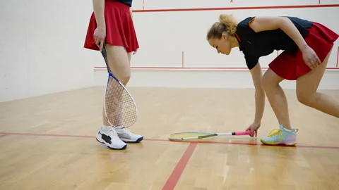 Women squash player spins racket and begins game on court Stock Footage 228746448