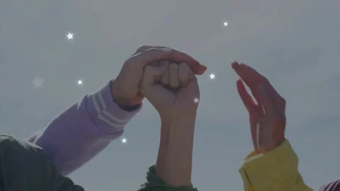 Women stacking hands over raised fist, inviting unity for business as stars Stock Footage 333477927