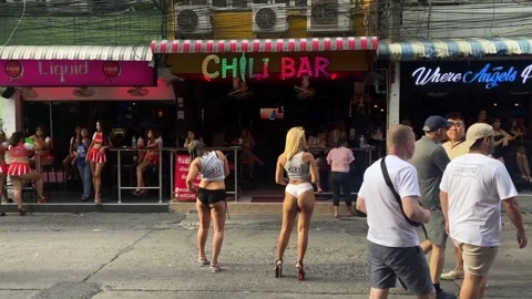 Women stand in front of bars waiting for customers in Pattaya, Thailand 4K Stock Footage 241142053