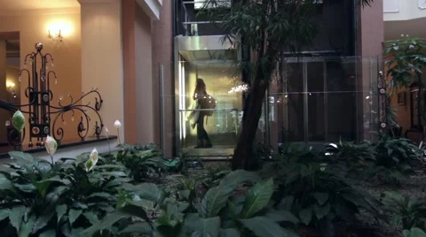 Women take the elevator on the ground floor to the first floor of the hotel Stock Footage 60056672