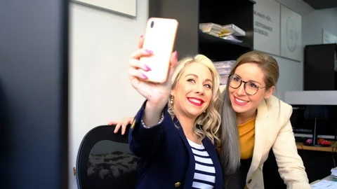 Women taking selfies at work | Stock Video | Pond5