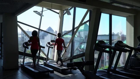 Women talk during the training. Runner trains indoors Stock Footage 76986058