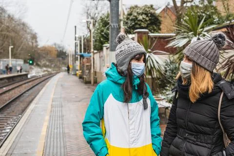 Women talking in a train platform Stock Photos