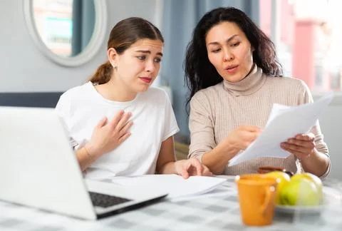 Women trying to solve document problem at home Stock Photos