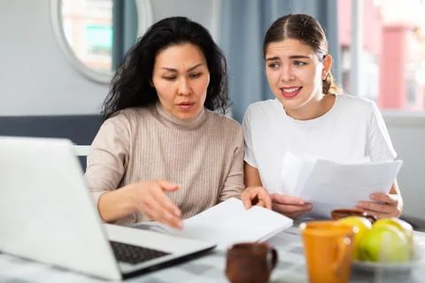 Women trying to solve document problem at home Stock Photos
