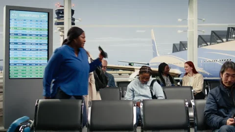 Women upset by delayed flight while commuting in airport transport hub Video stock 333108228