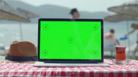 Women use a green screen computer on the beach. Stock Footage 144385873