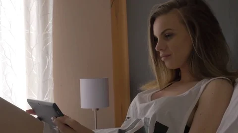 Women use tablet in bed Stock Footage 75762274