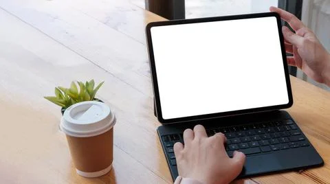 Women using laptop computer working at home with blank white desktop screen. Stock Photos