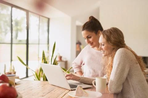 Women using laptop at dining table Stock Photos