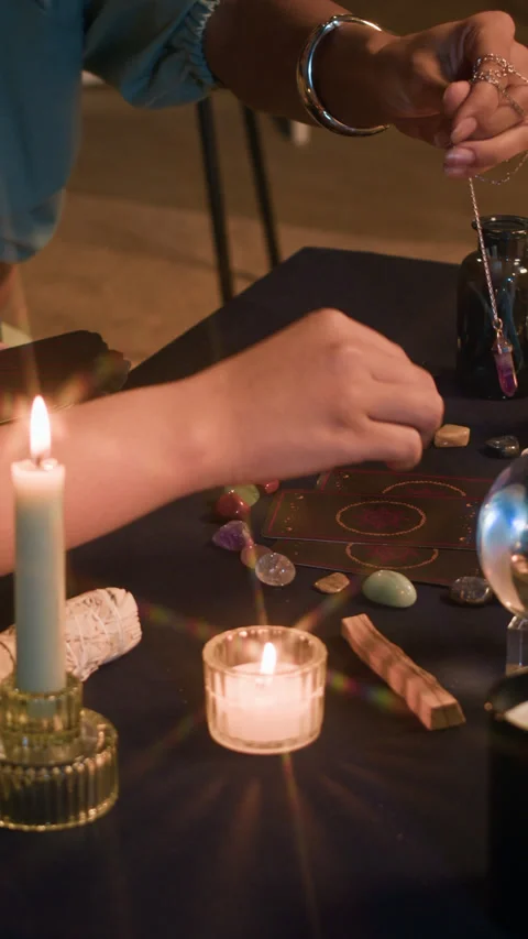 Women Using Pendulum and Tarot Cards during Fortune Telling Session Stock Footage 299197748