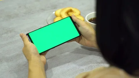 Women using smart phone slide finger green screen horizontal Video stock 113045253