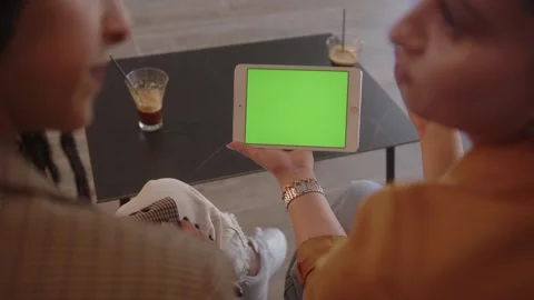 Women using tablet with green background scrolling and talking, close-up Stock Footage 244601901